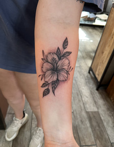 flowers on arm tattoo