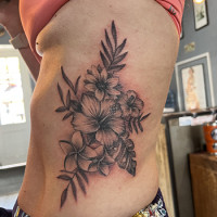 flowers on side tattoo