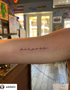 hand writing on arm tattoo